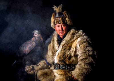 Botei Rys, a Kazakh Eagle Hunter sitting inside his room with his eagle.