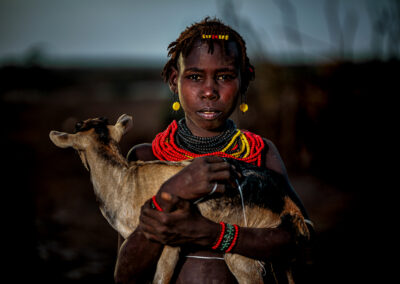 A Daasanach young girl with her sheep in the Omo Valley, Ethiopia.