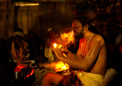 A Naga Sadhu smokes a chillum at the Maha Kumbh Mela in Allahabad, India