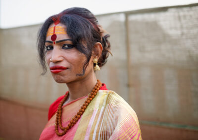 A transgender sadhu of the Kinnar Akhada during Ardh Kumbh Mela in Prayagraj. In a historic first during the 2019 Kumbh Mela, a group of transgender sadhus, known as the Kinnar Akhada, made their debut. Led by transgender activist Laxmi Narayan Tripathi, a former reality TV star and prominent activist known for her distinctive tattoos, the group's members adorn themselves in vibrant sarees and jewellery, making a striking appearance at the festival. Traditionally, akhadas have been male-dominated, with no akhadas led by cisgender women and only a few women ascetic members in certain groups. However, the transgender religious order was embraced by the Juna Akhada, the oldest and largest of the 13 sects that establish camps at every Kumbh to conduct prayers, religious lectures, and blessings for visitors. Inclusion in the Juna Akhada granted transgender members the privilege to participate in the royal holy dip (shahi snan) on auspicious days at the confluence of rivers in Prayagraj, ahead of millions of other pilgrims.