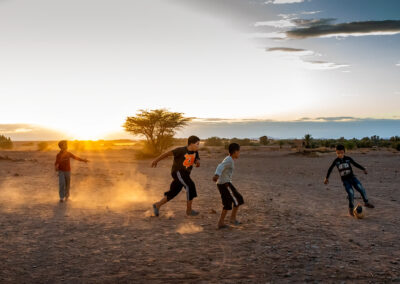 Four young boys are playing on the field at Tafraout Sidi Ali, a small remote village in Morocco.