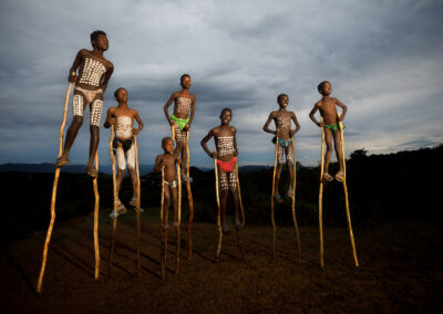 A group of Banna tribal boys walking with sticks, Omo Valley, Ethiopia.